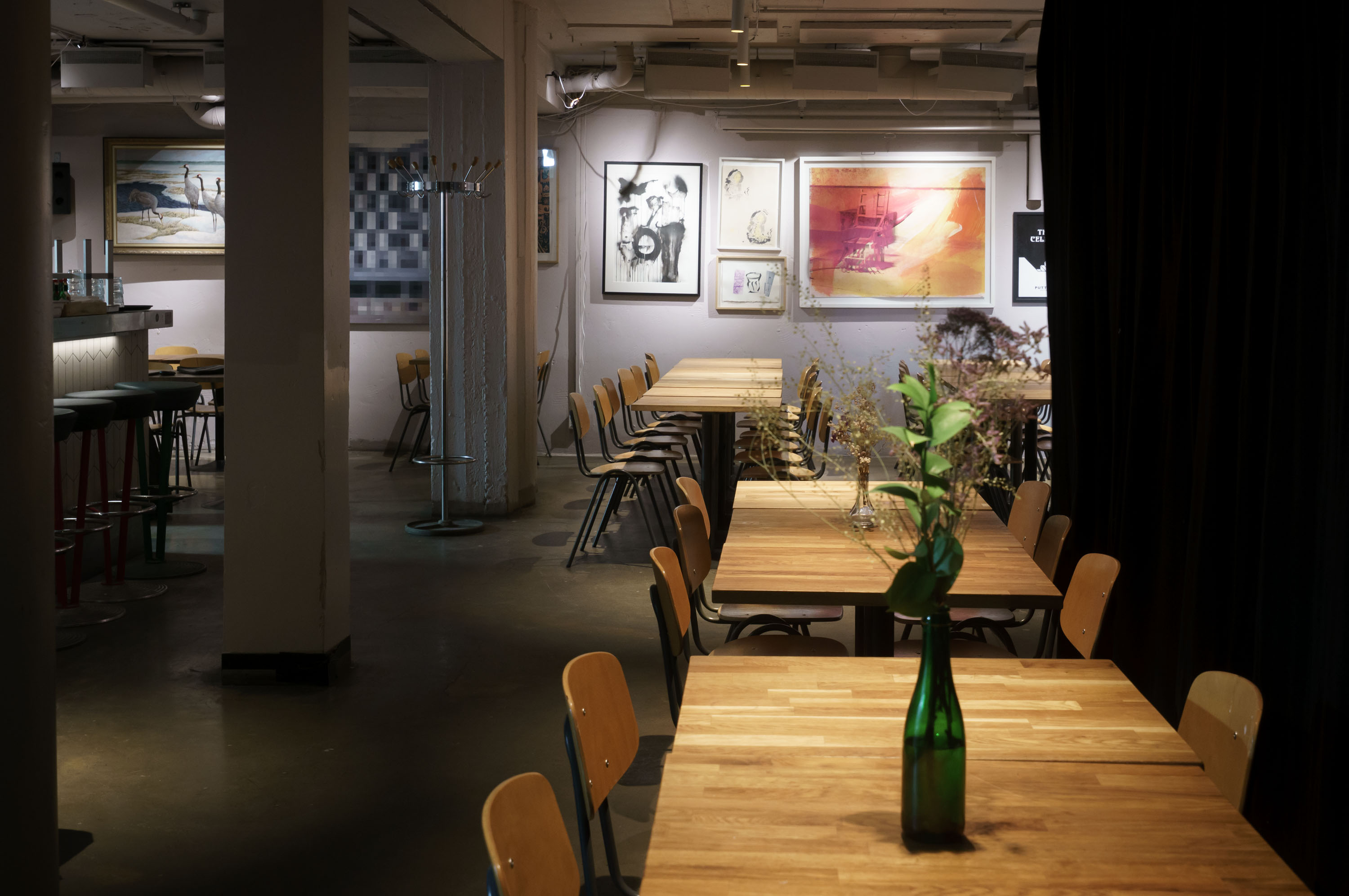 Cellar tables, flowers and illuminated artwork